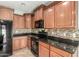 Close-up of the kitchen, showcasing the cabinetry, countertops, and black appliances at 7622 S 69Th Dr, Laveen, AZ 85339