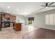 Open kitchen with black appliances, wood cabinets, granite counters, tile backsplash, and a center island with a breakfast bar at 7622 S 69Th Dr, Laveen, AZ 85339