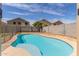 Backyard pool surrounded by a concrete deck and block wall, providing a relaxing and private outdoor space at 7622 S 69Th Dr, Laveen, AZ 85339