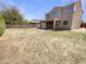Large backyard with a covered patio and block fence, presenting a blank canvas for landscaping at 7924 S 70Th Ln, Laveen, AZ 85339