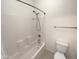 Bathroom with a shower-tub combo and a white toilet with tile flooring at 7924 S 70Th Ln, Laveen, AZ 85339