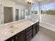 Bright primary bathroom with a double vanity, soaking tub, and a glass-enclosed shower at 7924 S 70Th Ln, Laveen, AZ 85339