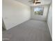 Light-filled bedroom featuring neutral paint, carpeting and a ceiling fan at 7924 S 70Th Ln, Laveen, AZ 85339