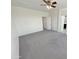 A bright room with carpet floors, a ceiling fan, and two doors to other rooms at 7924 S 70Th Ln, Laveen, AZ 85339