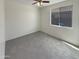 Cozy bedroom with plush carpet and a window providing natural light at 7924 S 70Th Ln, Laveen, AZ 85339