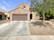 Tan two-story home with a two-car garage and landscaped front yard with a concrete driveway at 7924 S 70Th Ln, Laveen, AZ 85339