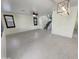Bright open-concept living area with tile flooring and a modern lighting fixture at 7924 S 70Th Ln, Laveen, AZ 85339