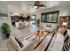 Bright, open-concept living area with tile floors, neutral furniture, and an eat-in kitchen at 7924 S 70Th Ln, Laveen, AZ 85339