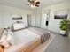 Cozy primary bedroom featuring carpet floors, ceiling fan, and ample natural light at 7924 S 70Th Ln, Laveen, AZ 85339