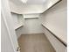 Walk-in closet with carpet flooring and wood storage shelving at 7924 S 70Th Ln, Laveen, AZ 85339