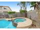 A refreshing backyard pool and spa area with a decorative tile border, surrounded by lush landscaping and a privacy wall at 7971 W Montebello Ave, Glendale, AZ 85303