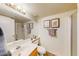 Well-lit bathroom featuring a wide mirror, a functional shower, and a clean, classic design at 7971 W Montebello Ave, Glendale, AZ 85303