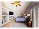 Cozy bedroom with built-in shelving, a ceiling fan, and natural light creating a relaxing atmosphere at 7971 W Montebello Ave, Glendale, AZ 85303