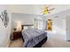Bright bedroom with a ceiling fan, private french door access to a bathroom, and ample natural light at 7971 W Montebello Ave, Glendale, AZ 85303