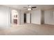 Large bedroom with carpet, ceiling fan and 3 entries to bath, hallway and closet at 901 S Storment Ln, Gilbert, AZ 85296