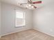 This is a bedroom with neutral carpeting, ceiling fan and a window allowing for lots of natural light to enter the home at 901 S Storment Ln, Gilbert, AZ 85296