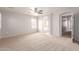 Large bedroom with neutral carpet and three entries to bathroom, hallway and closet at 901 S Storment Ln, Gilbert, AZ 85296