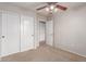 This is a bedroom featuring neutral carpeting and a double door closet and access to the ensuite bathroom at 901 S Storment Ln, Gilbert, AZ 85296