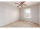 The bedroom features a ceiling fan and a window allowing for lots of natural light to enter the home at 901 S Storment Ln, Gilbert, AZ 85296