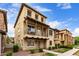 Beautiful three-story home with balcony, desert landscaping, and traditional architectural details at 901 S Storment Ln, Gilbert, AZ 85296