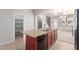 Kitchen island with granite counters, stainless appliances and cherry wood cabinetry at 901 S Storment Ln, Gilbert, AZ 85296