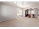 Open-concept living room featuring carpet, a window, and an arched entryway to the kitchen at 901 S Storment Ln, Gilbert, AZ 85296