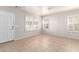 Bright living room featuring tile floors, plantation shutters, and fresh paint at 901 S Storment Ln, Gilbert, AZ 85296