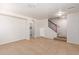 Spacious living room with tile flooring, a staircase, and an arched doorway to the laundry room at 901 S Storment Ln, Gilbert, AZ 85296