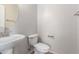 Powder room featuring a pedestal sink and white toilet at 901 S Storment Ln, Gilbert, AZ 85296
