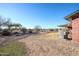 Large backyard featuring mature trees, gravel area, and a covered patio at 9735 W Ironwood Dr # A, Peoria, AZ 85345