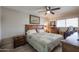 Cozy bedroom with wood furnishings, comfortable quilt, and natural light from a window at 9735 W Ironwood Dr # A, Peoria, AZ 85345