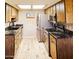 Galley kitchen featuring wood cabinets, stainless steel appliances, and granite countertops at 9735 W Ironwood Dr # A, Peoria, AZ 85345