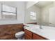Bathroom with large mirror, window, and stylish tile accent at 10064 E Kilarea Ave, Mesa, AZ 85209