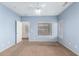 This bedroom offers neutral paint, dual windows, and views into the next room at 10064 E Kilarea Ave, Mesa, AZ 85209