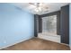 This bedroom offers neutral paint, a ceiling fan, and a window for plenty of natural light at 10064 E Kilarea Ave, Mesa, AZ 85209
