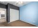 This bedroom features neutral paint, a ceiling fan, and a sliding door closet at 10064 E Kilarea Ave, Mesa, AZ 85209