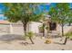 Charming single-story home with a well-maintained desert yard and a two car garage at 10064 E Kilarea Ave, Mesa, AZ 85209