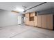 Spacious garage with ample storage cabinets and access door at 10064 E Kilarea Ave, Mesa, AZ 85209