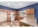 Bright kitchen with white appliances, light-colored cabinets, and ample counter space for cooking at 10064 E Kilarea Ave, Mesa, AZ 85209