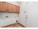 This laundry room offers an access door and plenty of storage cabinets at 10064 E Kilarea Ave, Mesa, AZ 85209
