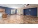 Spacious living room with tiled floors, a kitchen island, and natural lighting at 10064 E Kilarea Ave, Mesa, AZ 85209
