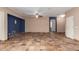 Spacious living room with tiled floors, modern lighting and an arched doorway at 10064 E Kilarea Ave, Mesa, AZ 85209