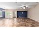 Spacious living room with tile flooring, ceiling fan, and natural light from a double glass door at 10064 E Kilarea Ave, Mesa, AZ 85209