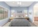Cozy main bedroom with a large bed, soft colors, and natural light from the large windows at 10064 E Kilarea Ave, Mesa, AZ 85209