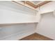 Spacious walk-in closet providing ample shelving and storage options for organizing personal items at 10064 E Kilarea Ave, Mesa, AZ 85209