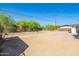 Large backyard with a dirt lot and chainlink fence on a sunny day at 1012 E Estevan Ave, Apache Junction, AZ 85119