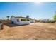 Wide backyard with plenty of open space and a freshly painted home exterior with contrasting black trim at 1012 E Estevan Ave, Apache Junction, AZ 85119