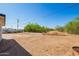 Spacious backyard area with an outdoor shed, offering ample room for various activities and potential garden at 1012 E Estevan Ave, Apache Junction, AZ 85119