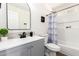 Bathroom with a gray vanity, faucet, bathtub, and shower featuring a white tile wall at 1012 E Estevan Ave, Apache Junction, AZ 85119