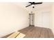 Bedroom featuring hardwood flooring, a ceiling fan, a closet, and fresh paint at 1012 E Estevan Ave, Apache Junction, AZ 85119